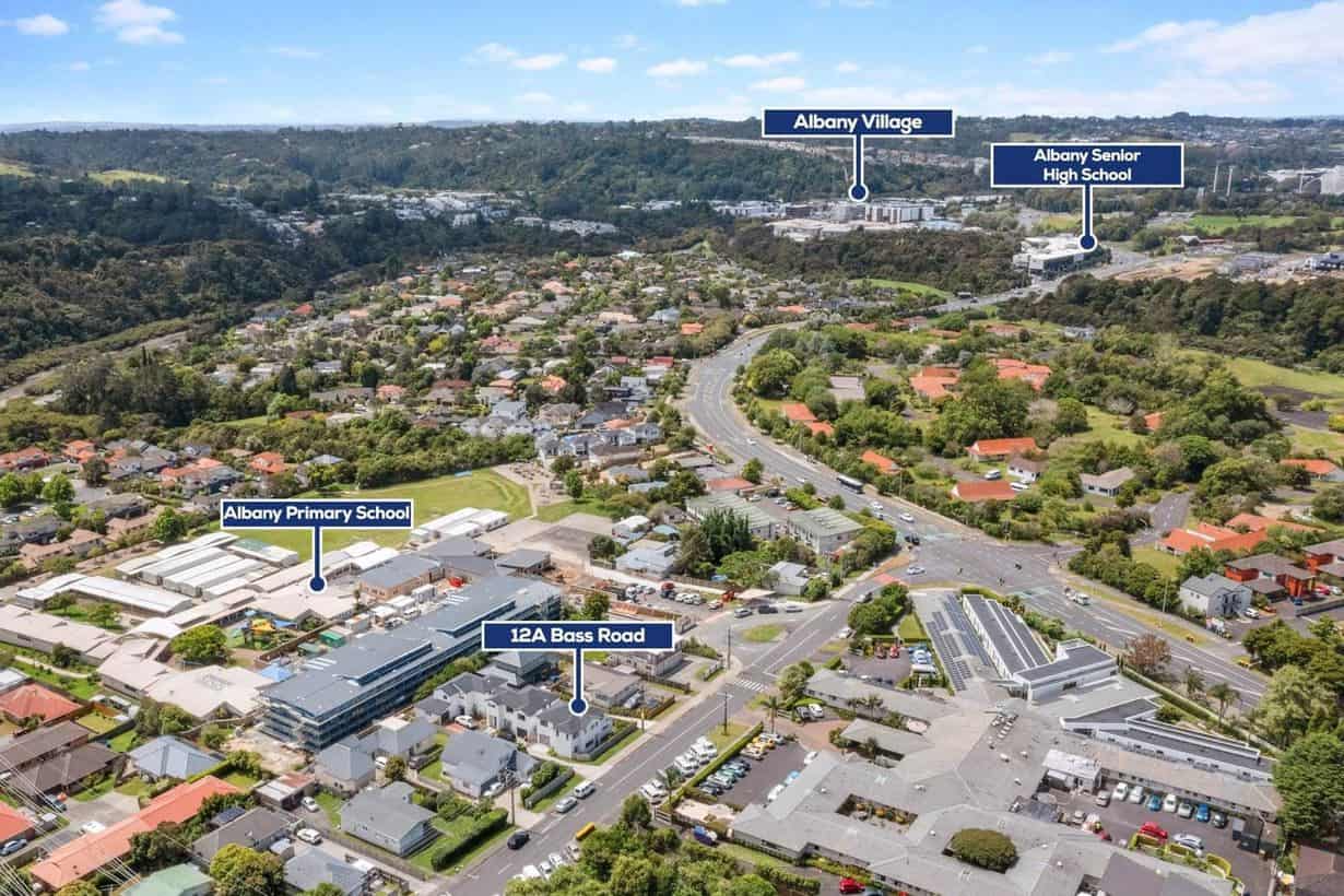 Aerial over Albany Village showing the village centre, local schools and the SH18 Bass Road interchange