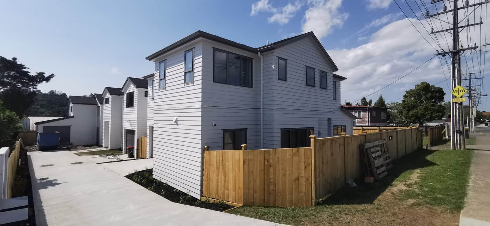 Two newly built two-storey houses on a subdivided site seen from the street, Albany Village