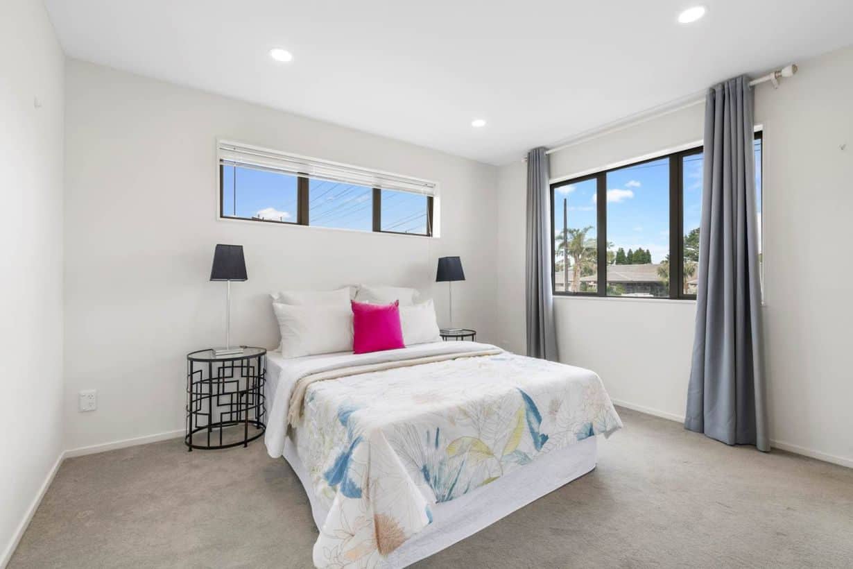 Bedroom with a clerestory window above the bed and a tall window to the side, Albany Village