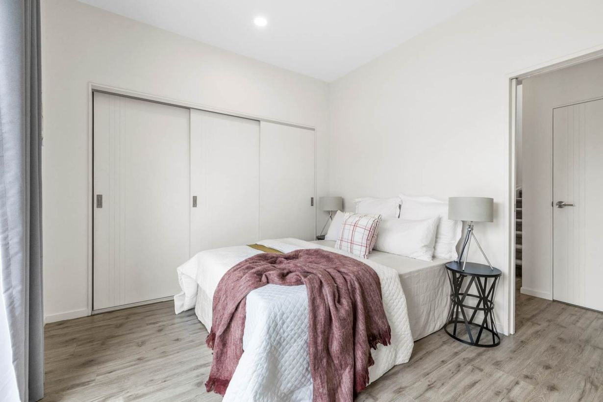 Bedroom with built-in wardrobes behind sliding doors, Albany Village