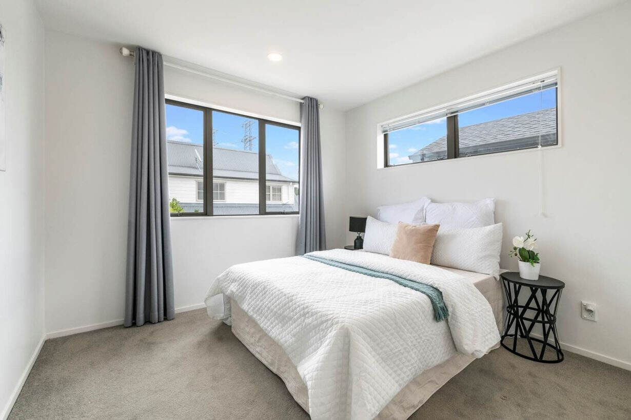 Bedroom with a corner window and a clerestory window above, Albany Village