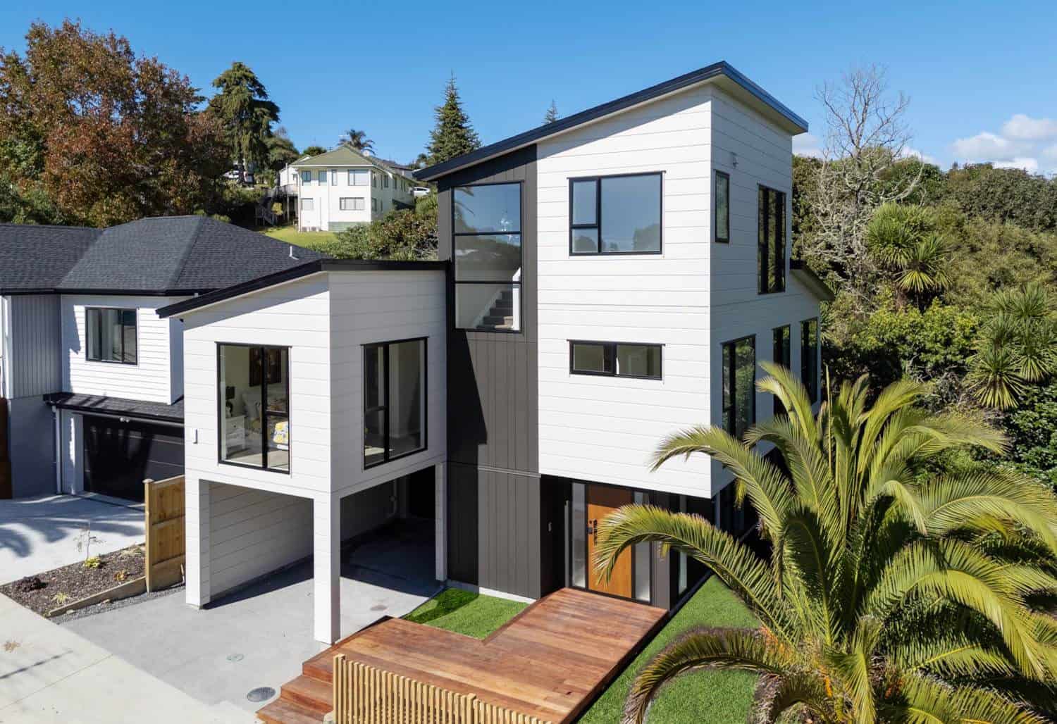 Three-level house seen from the street with an undercroft garage, Browns Bay
