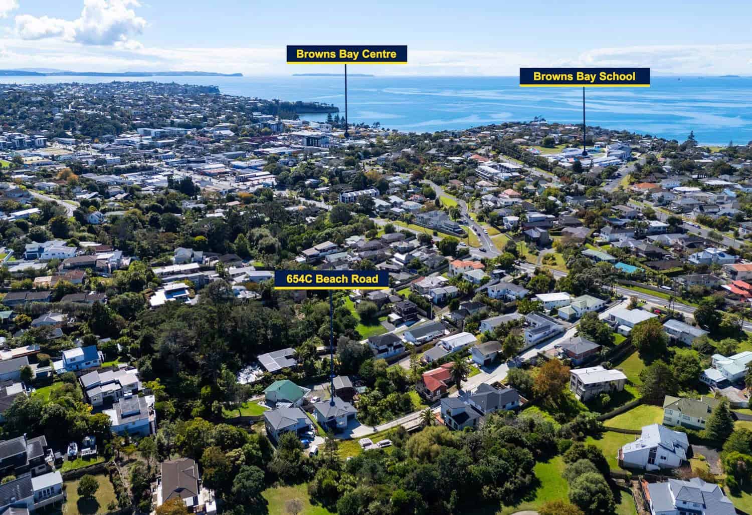 Aerial over Browns Bay showing the town centre, Browns Bay School and the surrounding streets