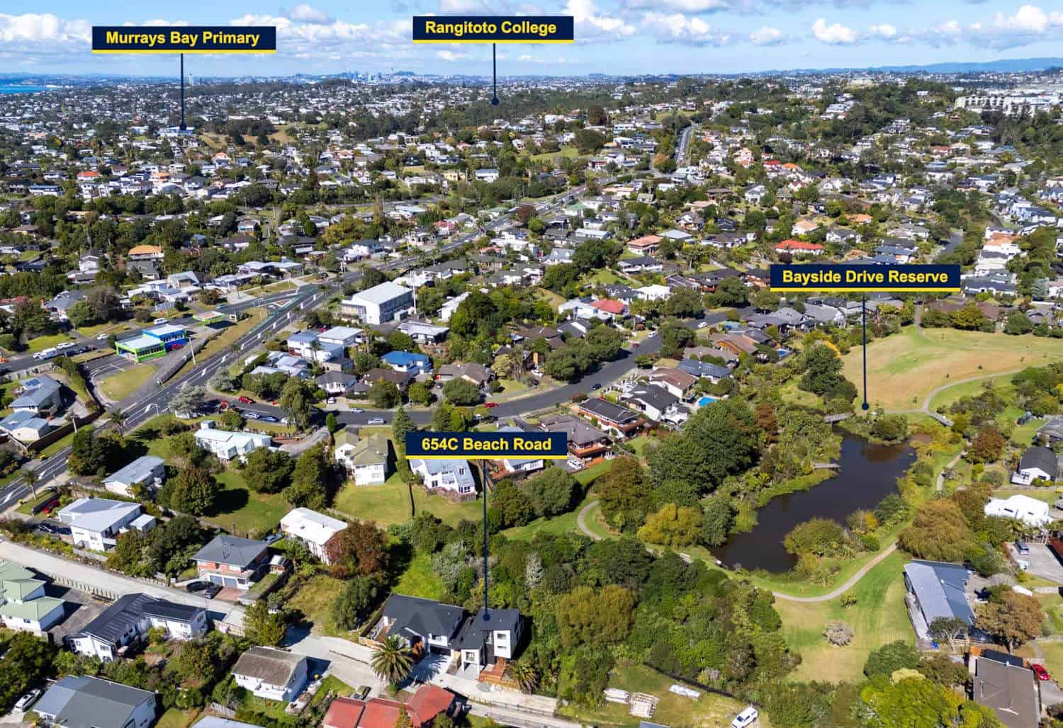 Aerial over Browns Bay marking Murrays Bay Primary, Rangitoto College and Bayside Drive Reserve