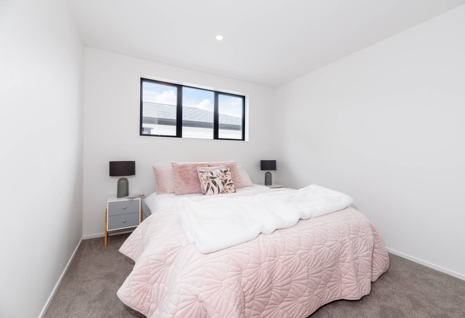 Bedroom with a high horizontal window and a pink bedspread, Blockhouse Bay