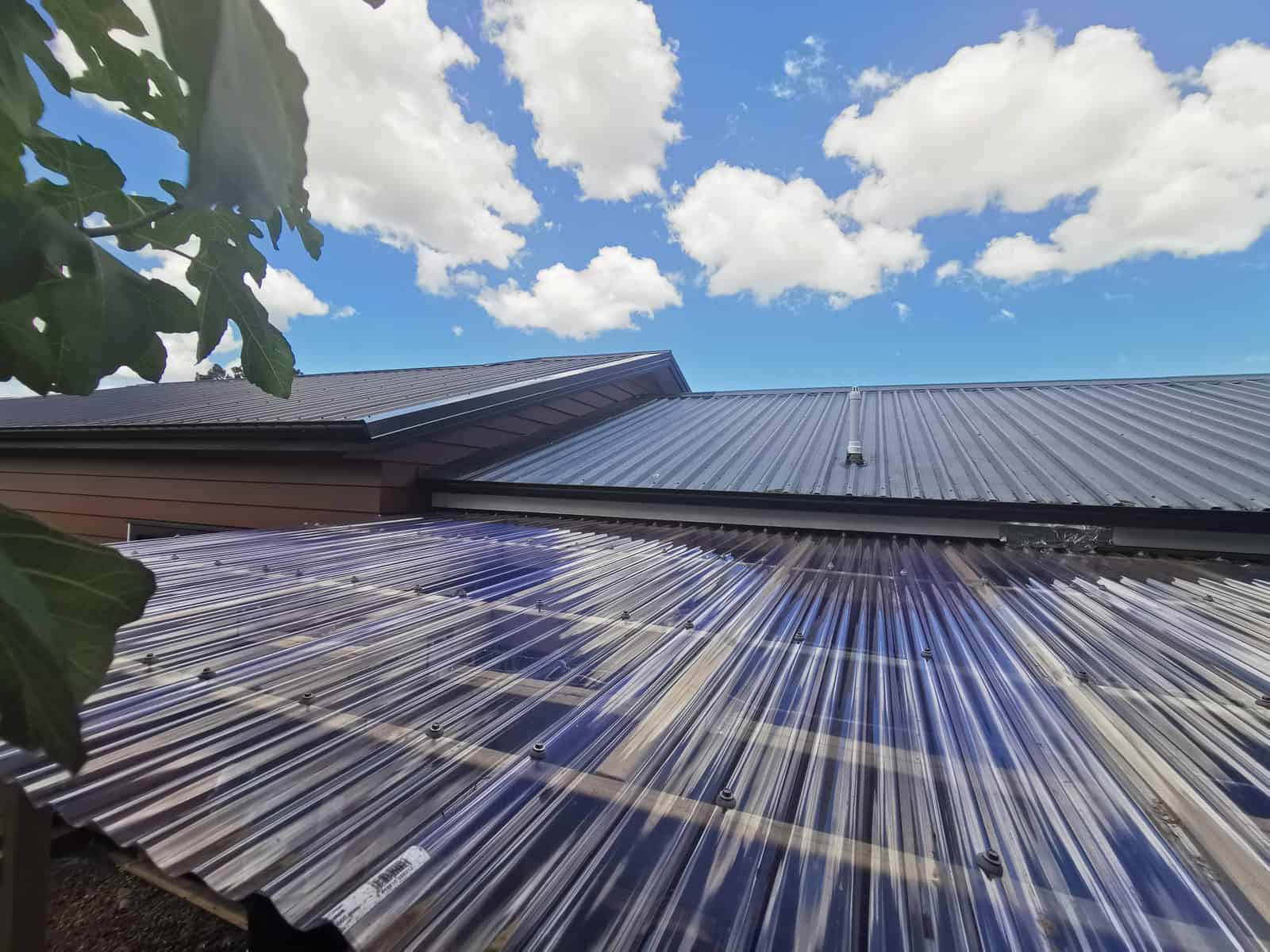 Looking along the corrugated polycarbonate roof of a lean-to beside the extension, Botany Downs