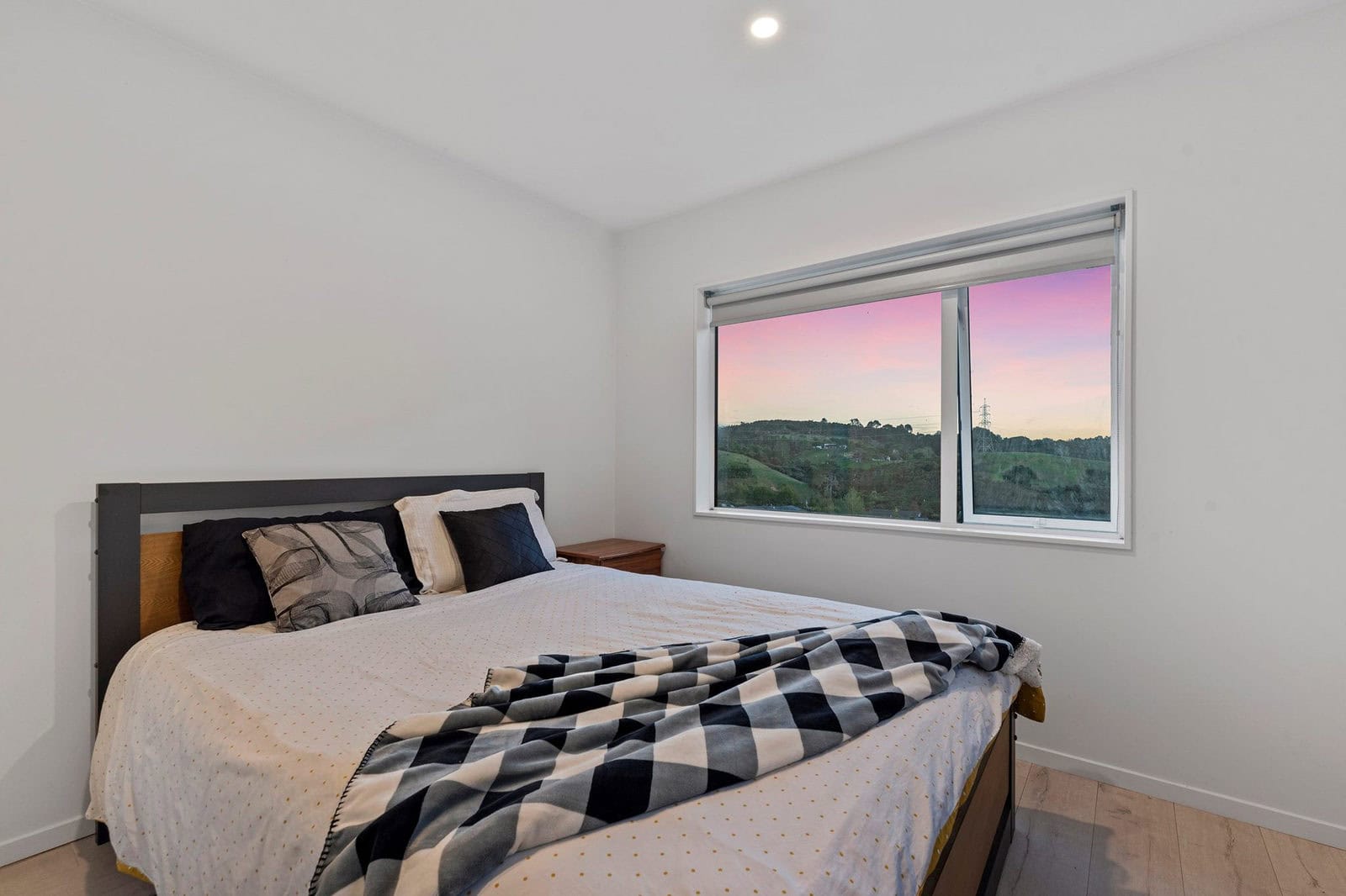 Bedroom with a window looking out to a rural sunset, Coatesville