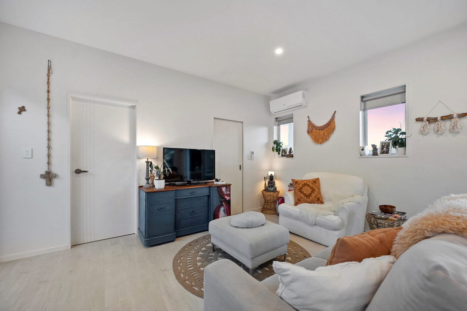 Living area with a sofa, ottoman and television on a blue sideboard, Coatesville