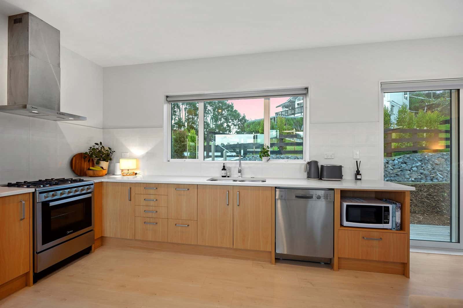 Kitchen with timber cabinetry, a freestanding cooker, dishwasher and rangehood, Coatesville