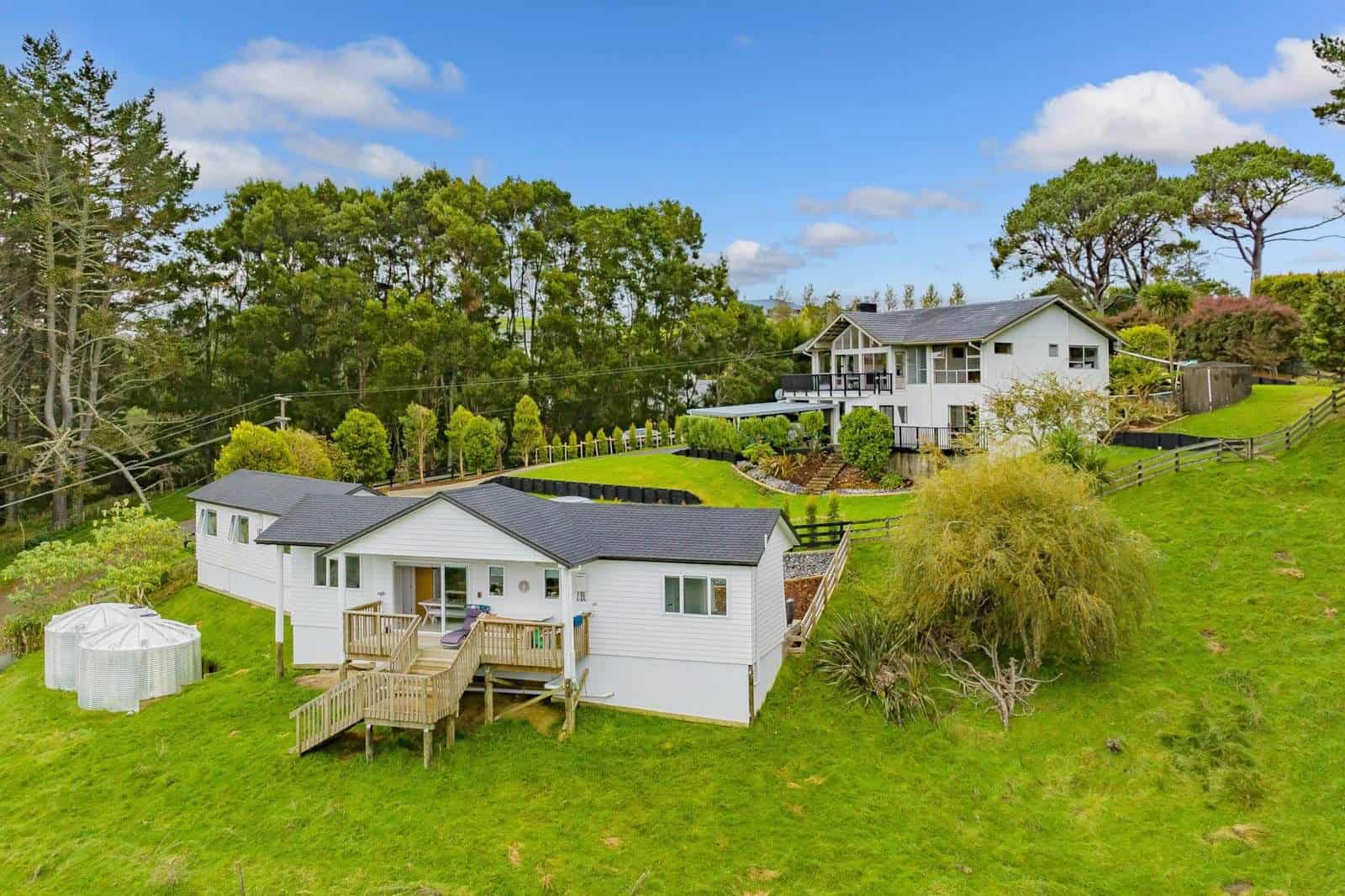 Aerial of the property with the main house above and the minor dwelling on the lawn below, Coatesville