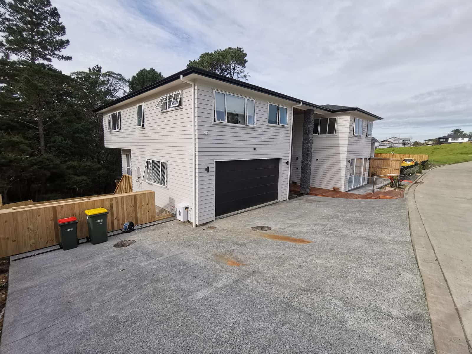 Driveway elevation of the finished two-storey house with its double garage, Albany