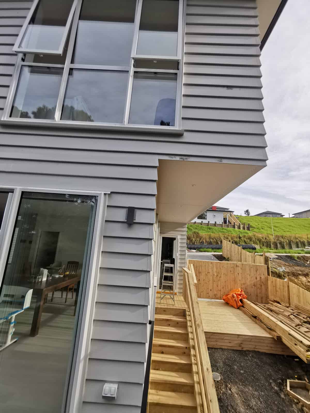 Upper level and sliding doors above the lower deck, seen from the side yard, Albany