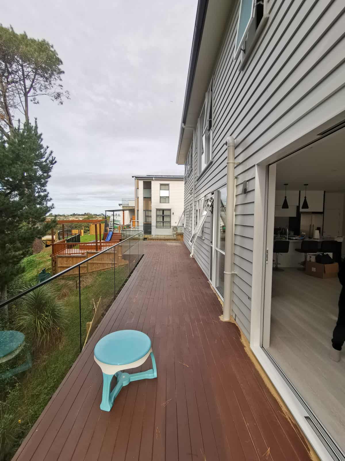Narrow timber deck running along the side of the house past the sliding doors, Albany