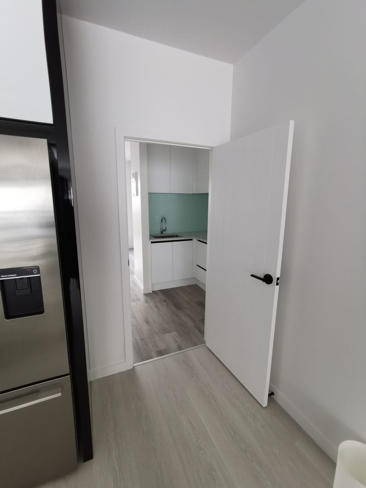 Hallway with a fridge alcove looking through to the kitchen, Albany
