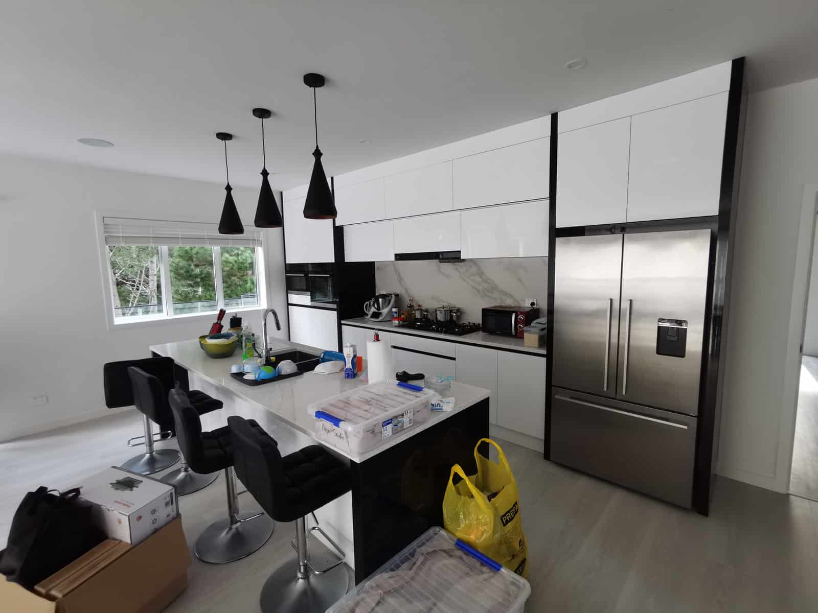 Kitchen with pendant lights over the island and a large fridge alongside, Albany