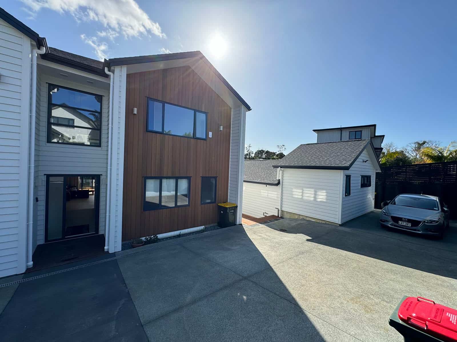 Driveway elevation with the timber-clad bay and the neighbouring garage, Greenhithe