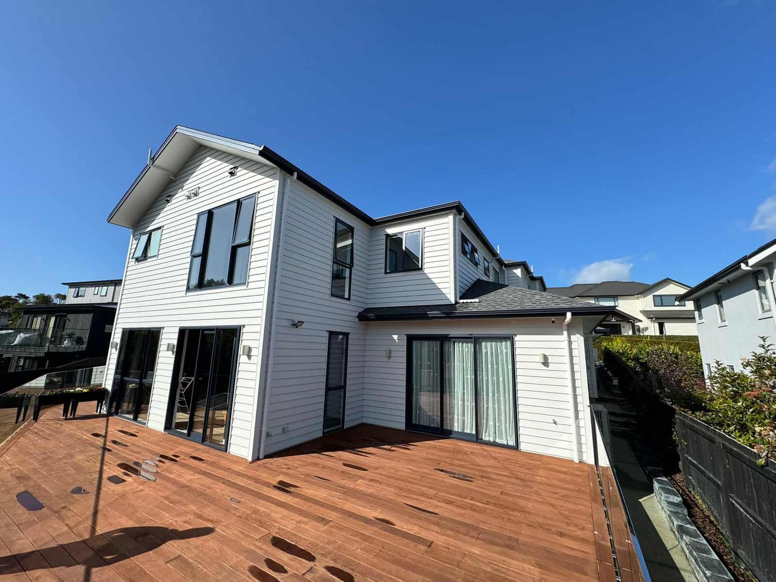 Rear of the house with sliding doors opening onto a large hardwood deck, Greenhithe