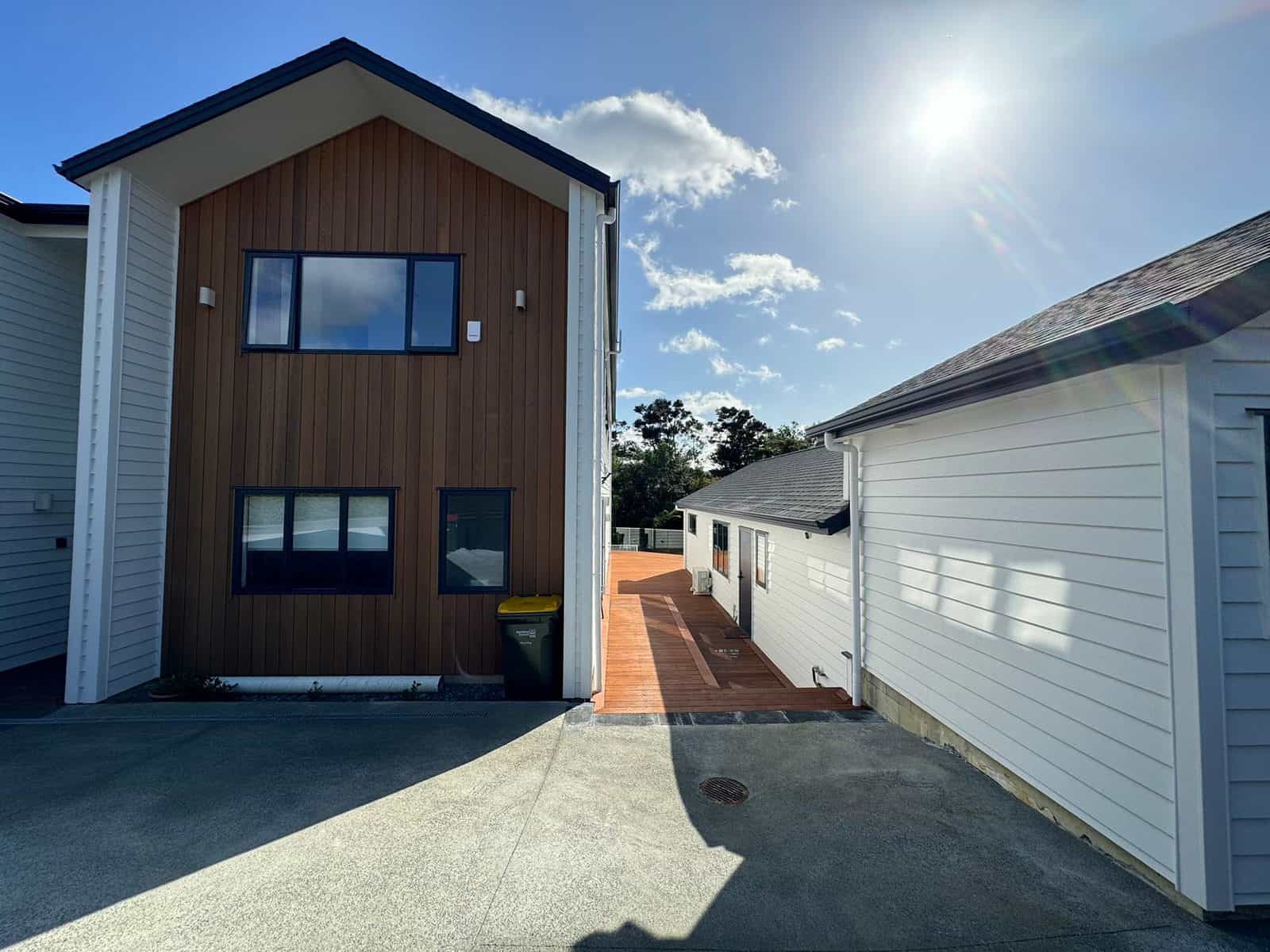 Timber-clad gable beside the paved drive with the garage opposite, Greenhithe