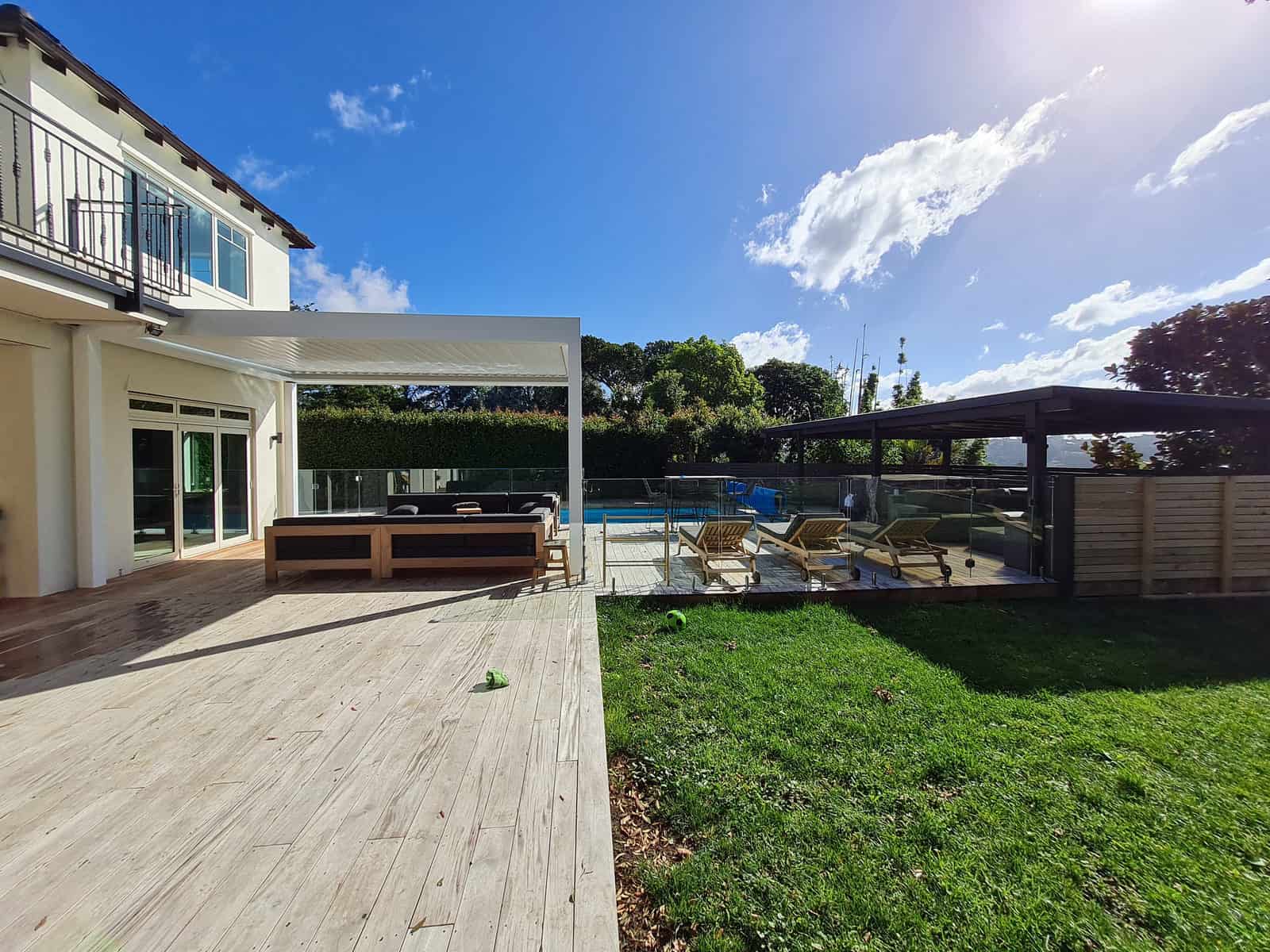 Pool shelter and deck seen from the lawn with the house behind, Greenhithe