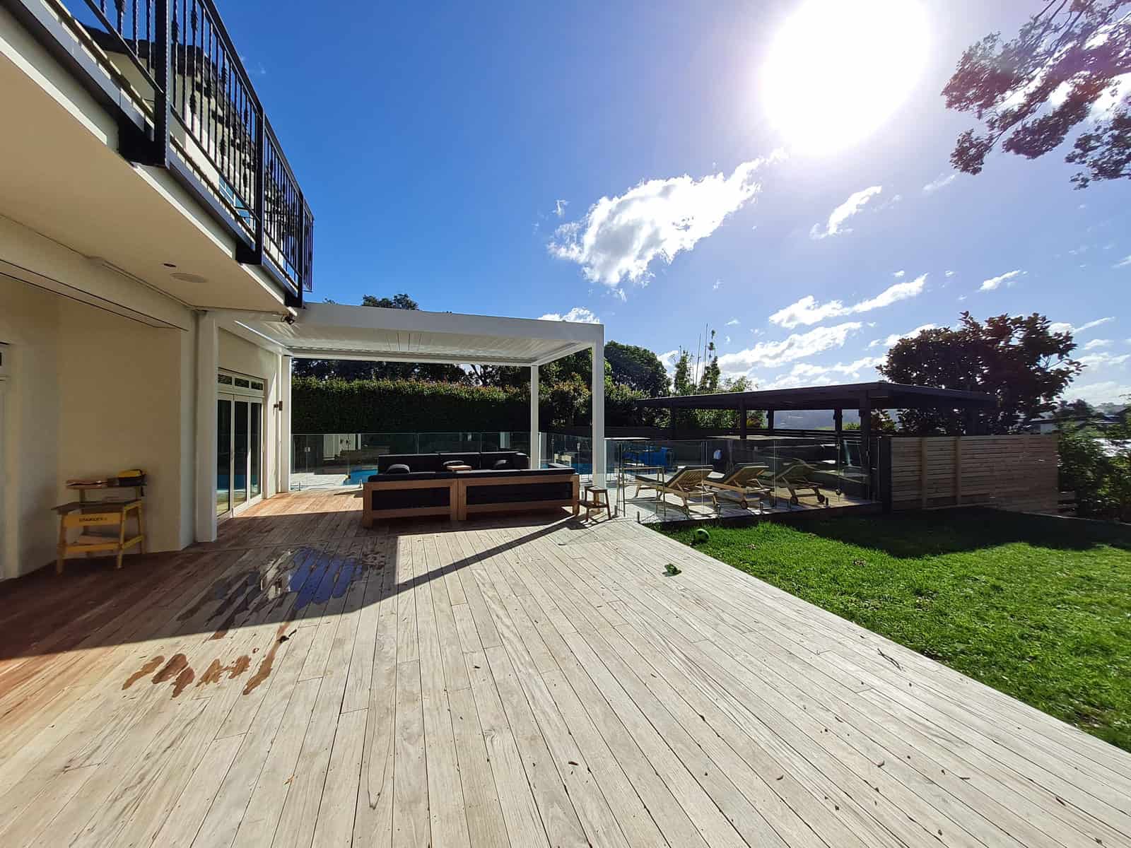 Wide timber deck running from the house out to the louvre pool shelter, Greenhithe