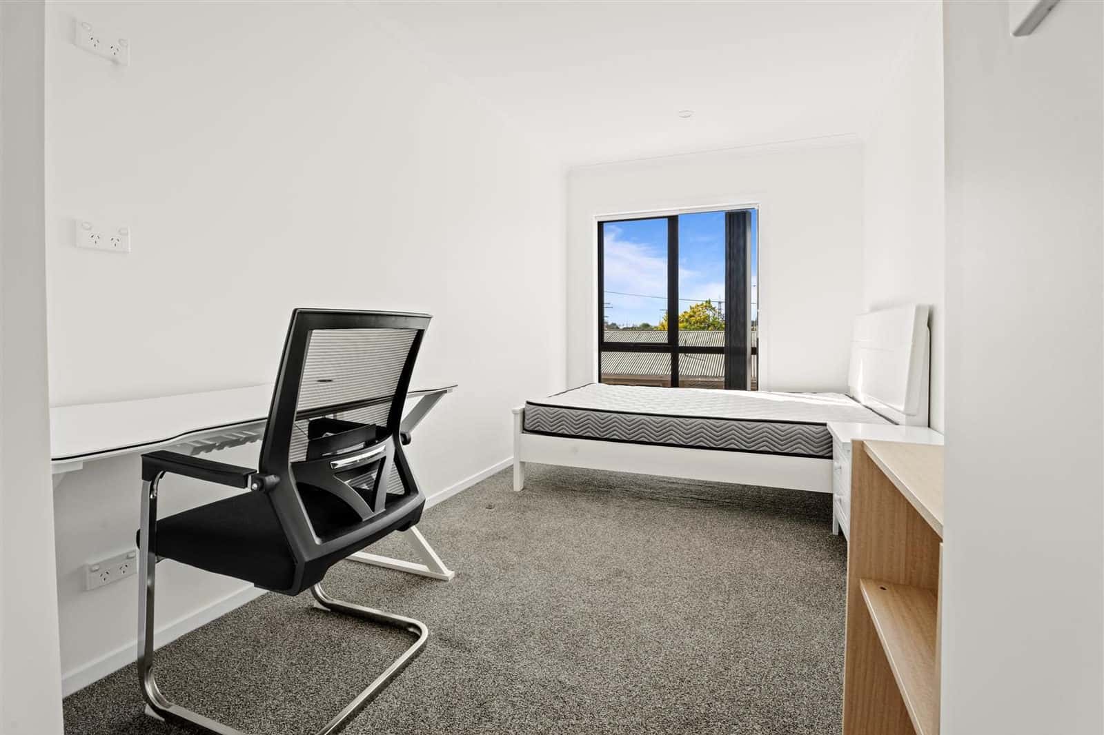 Bedroom set up as a study with a desk, chair and single bed, Hamilton