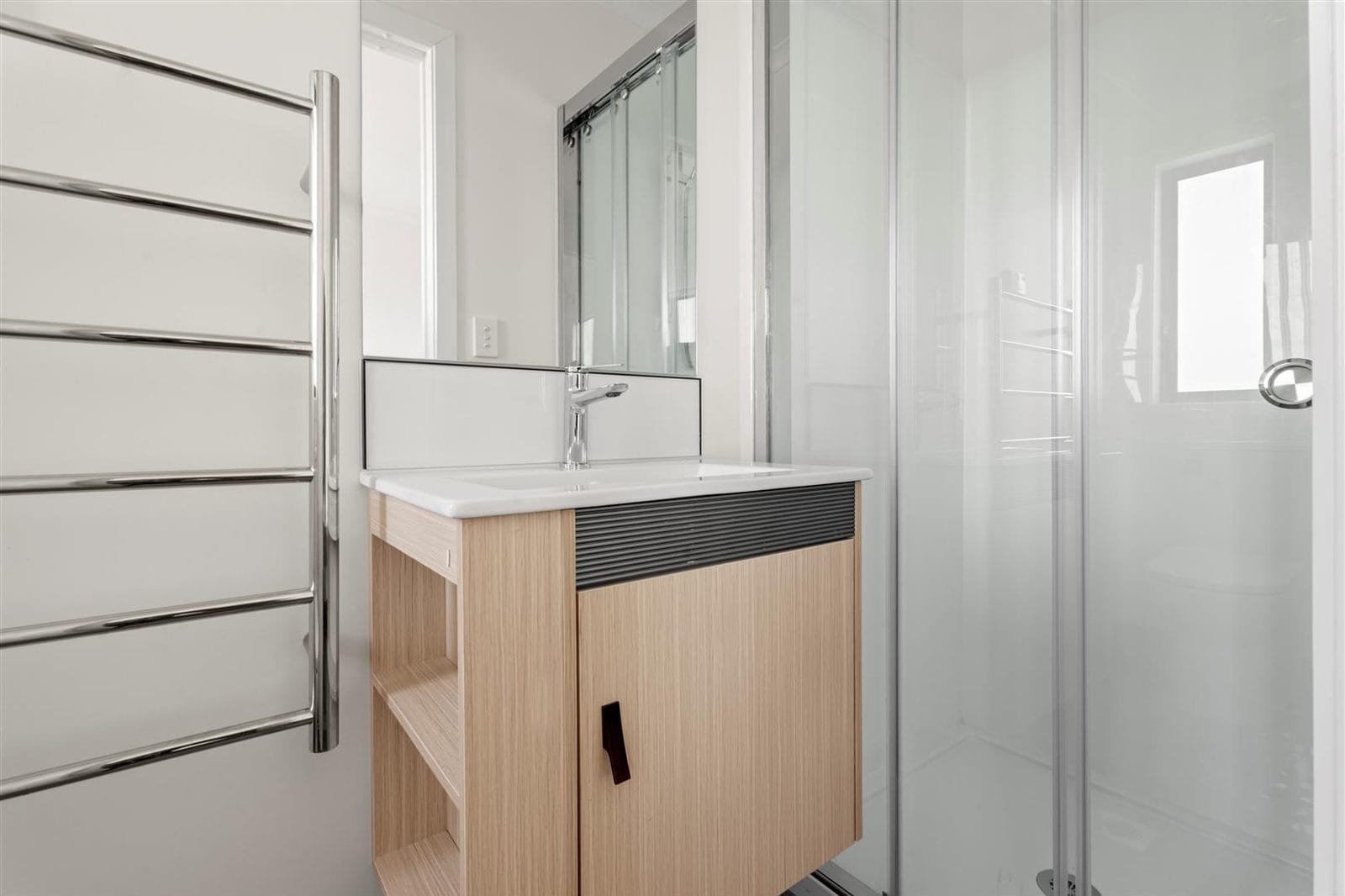 Bathroom with a timber vanity, heated towel rail and glazed shower, Hamilton