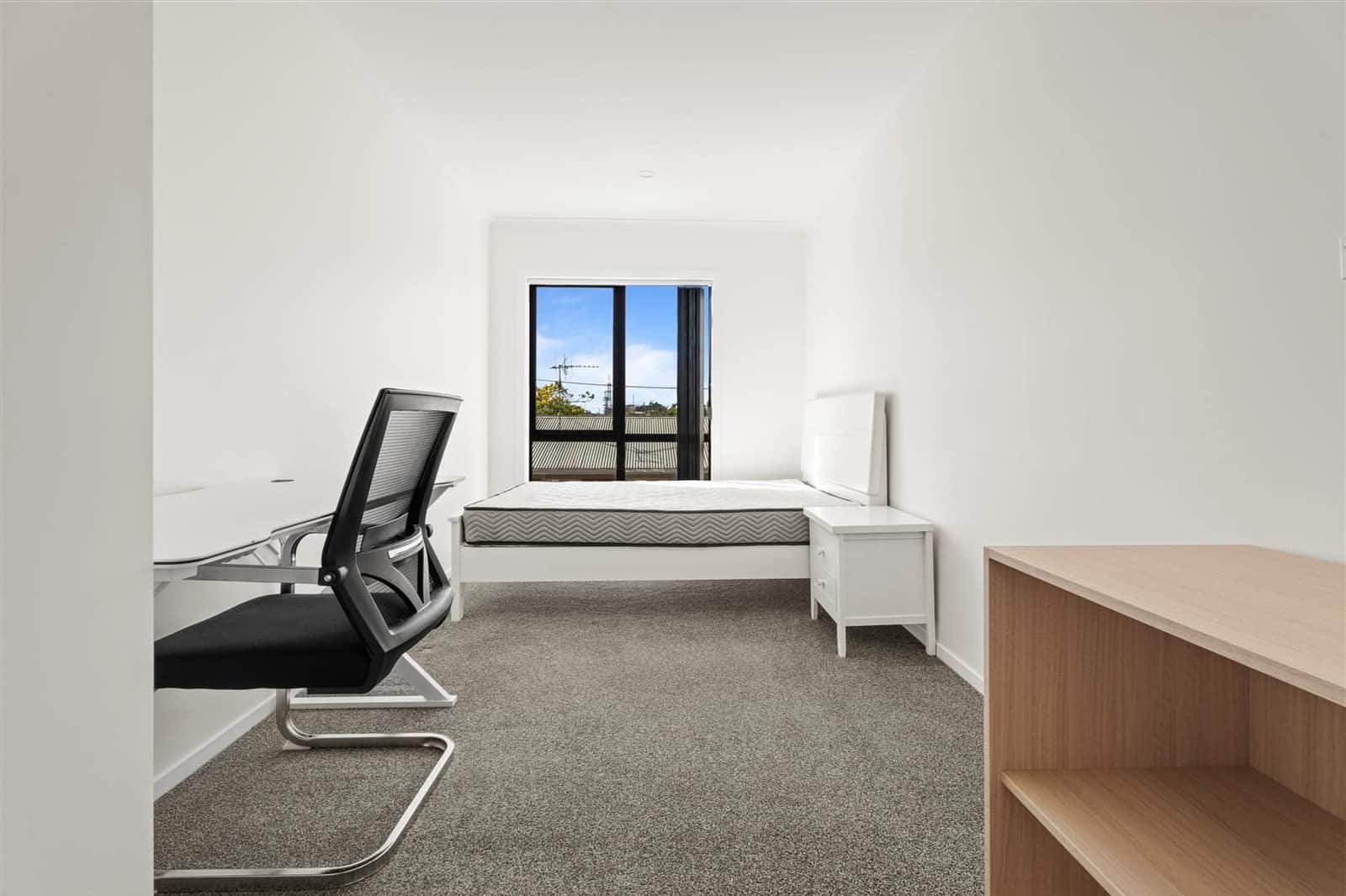 Bedroom set up as a study with a desk, office chair and single bed, Hamilton