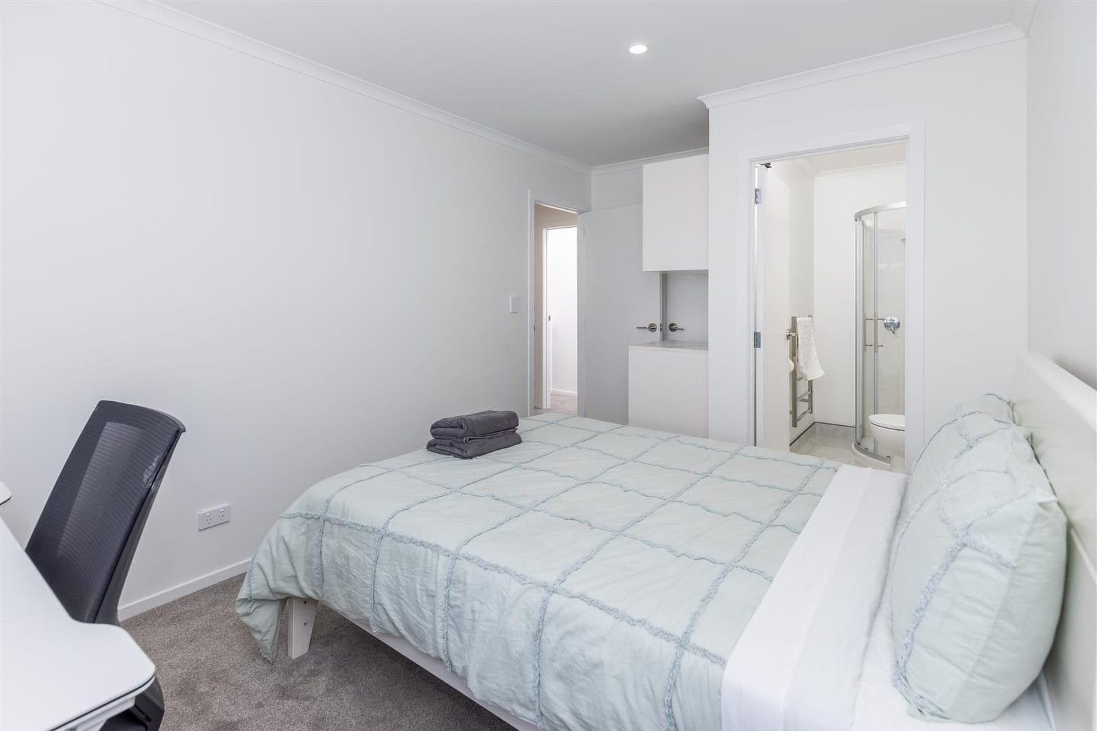 Bedroom with a desk and an ensuite visible through the doorway, Hamilton