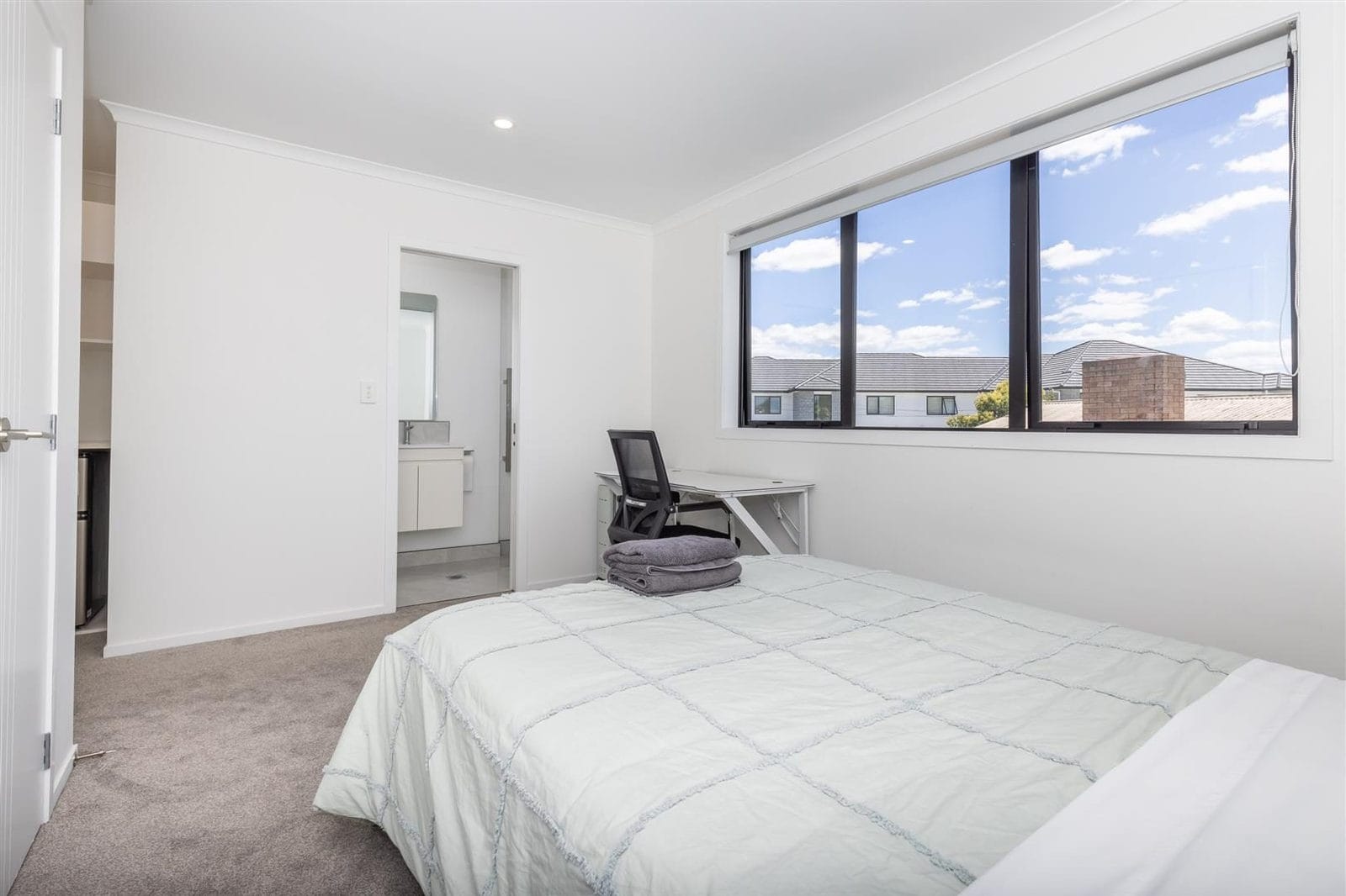Bedroom with a desk under a wide window looking over the neighbourhood, Hamilton