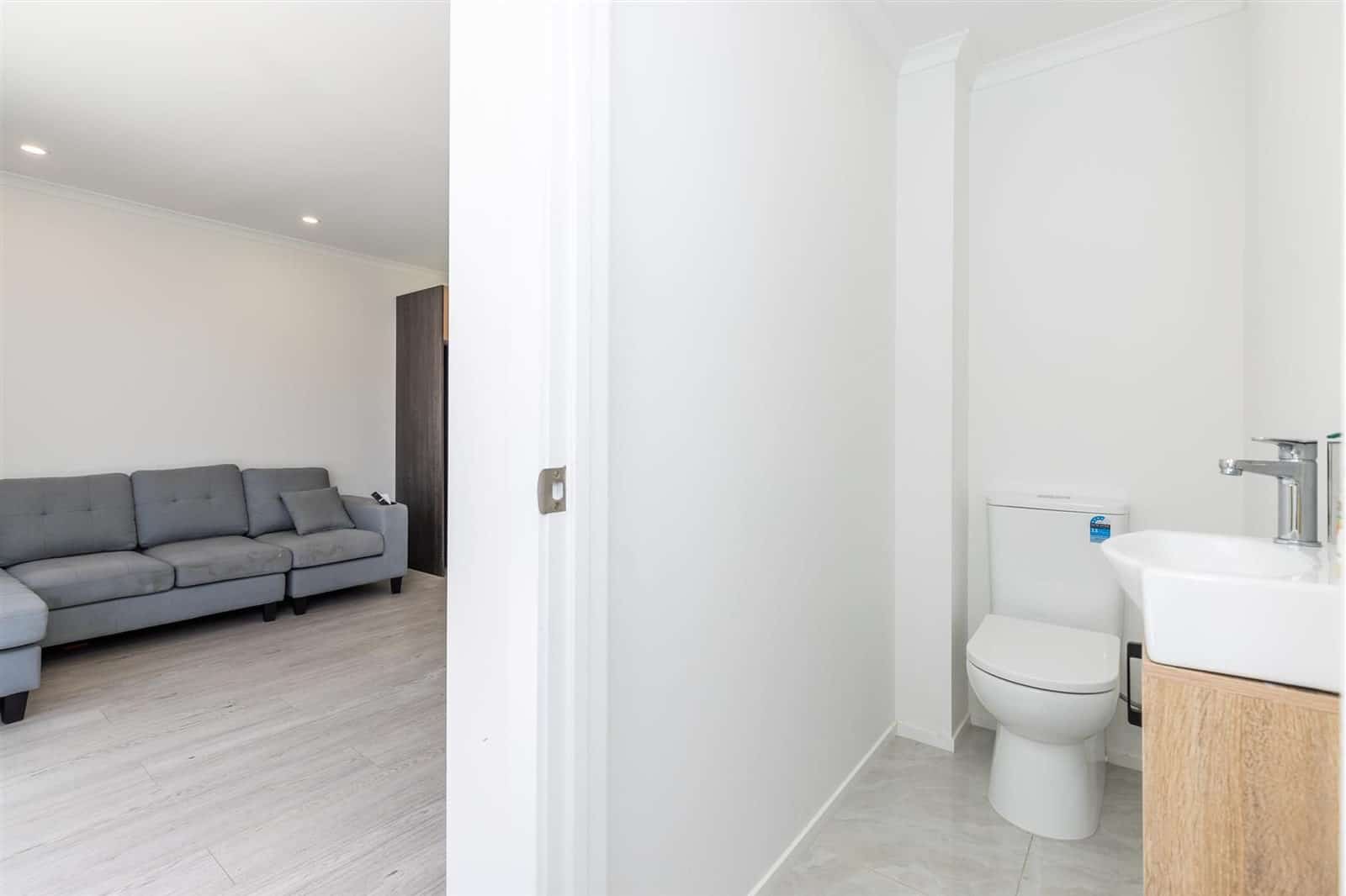 Living area with a toilet and basin off the hallway, Hamilton