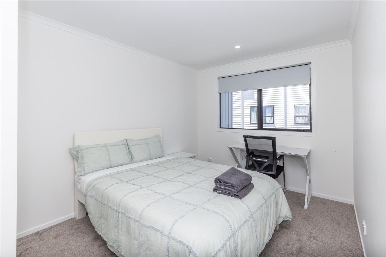 Bedroom with a bed, desk and a high window, Hamilton