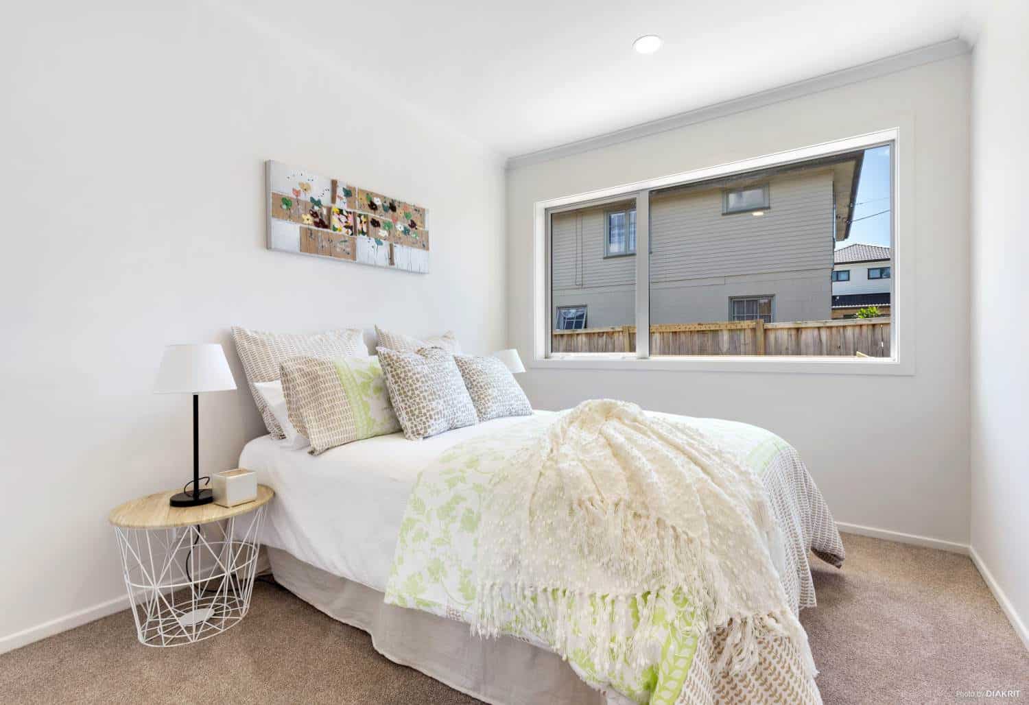 Bedroom with a window looking across to the neighbouring house, Te Atatu South