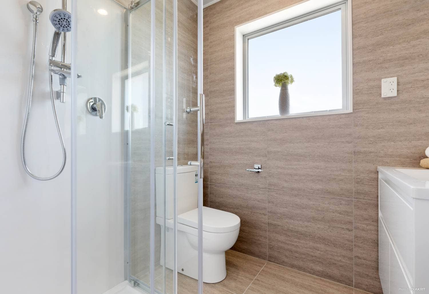 Bathroom with a glazed shower, toilet and timber-look tiling, Te Atatu South
