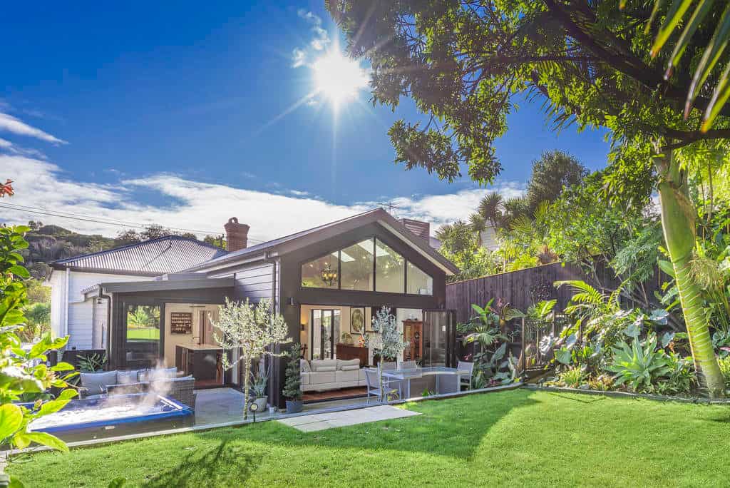 Contemporary gabled extension at the rear of the villa with lawn and pool, Kingsland