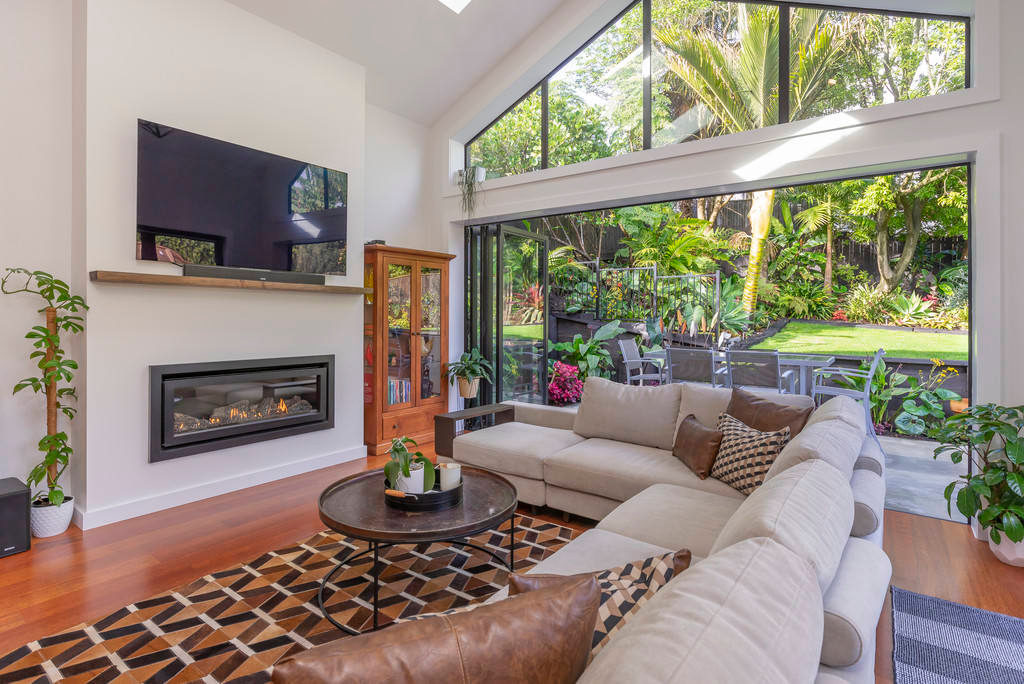 Living room with a gas fire and full-height glazing onto the garden, Kingsland