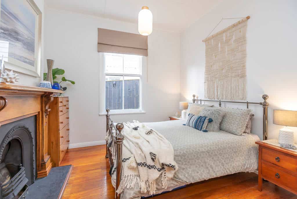 Bedroom in the original villa with a cast-iron fireplace and timber mantel, Kingsland