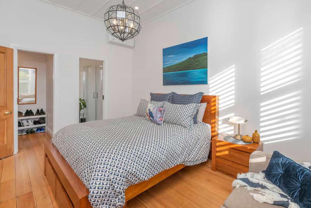 Bedroom with plantation shutters and a timber bed frame, Kingsland