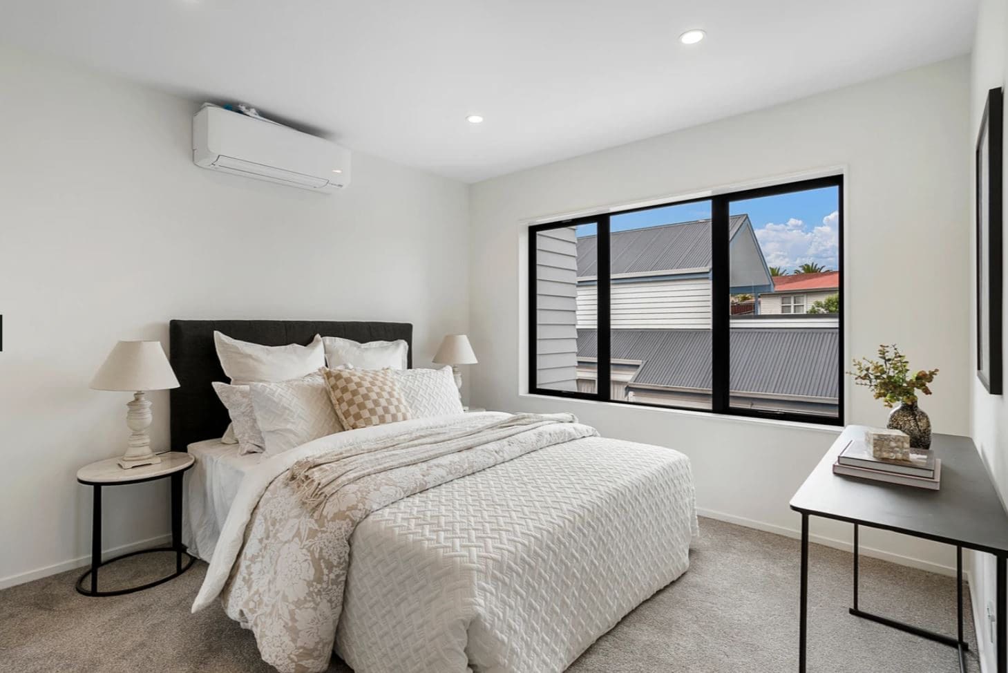 Bedroom with a high horizontal window and a heat pump above, Lynfield