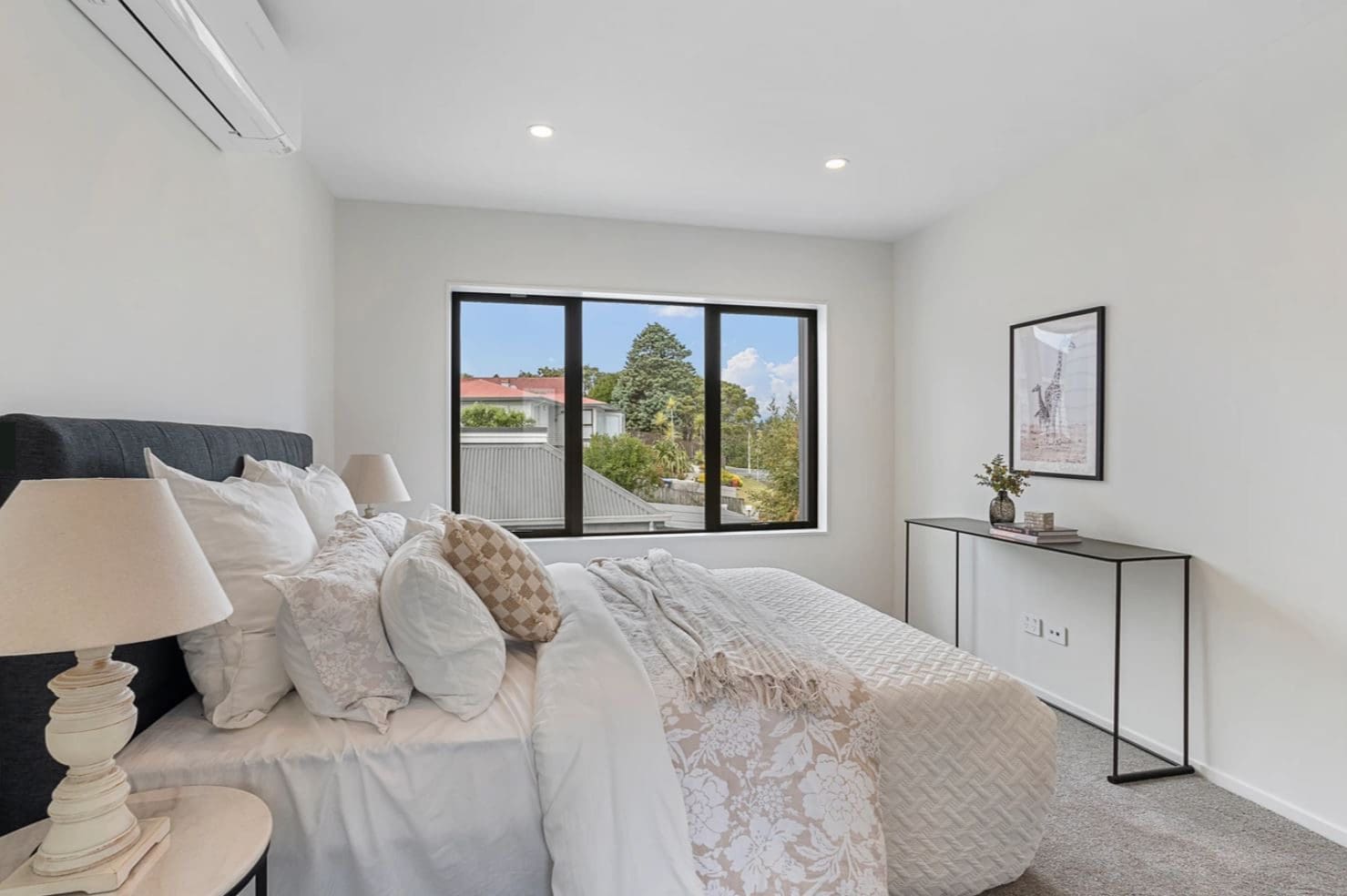Bedroom with a wide window looking over neighbouring roofs, Lynfield