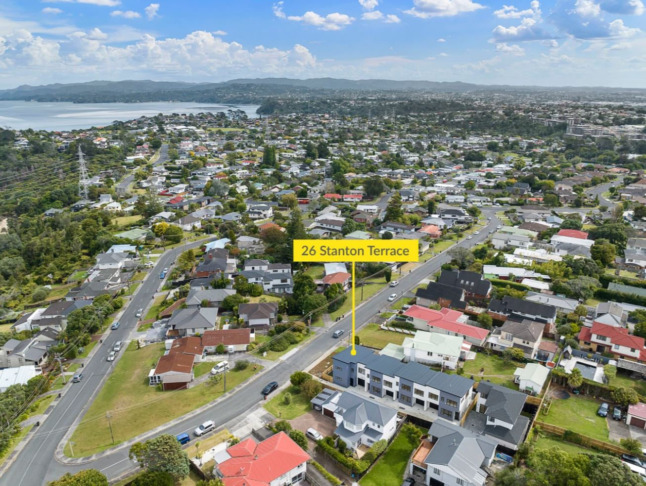 Aerial over Lynfield showing the subdivided site among the surrounding streets with the harbour beyond