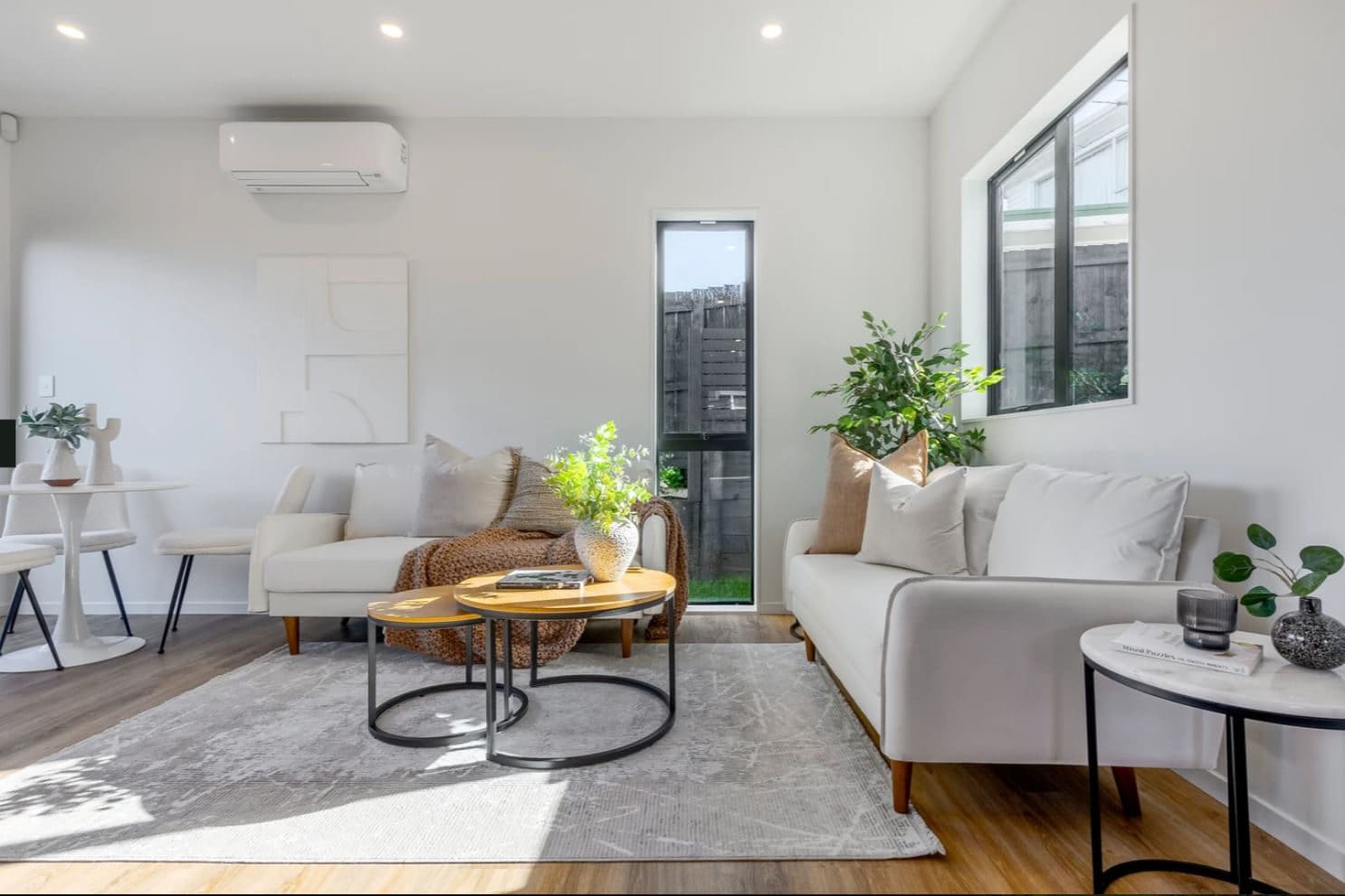 Living room with two sofas, a round coffee table and a glazed front door, Lynfield