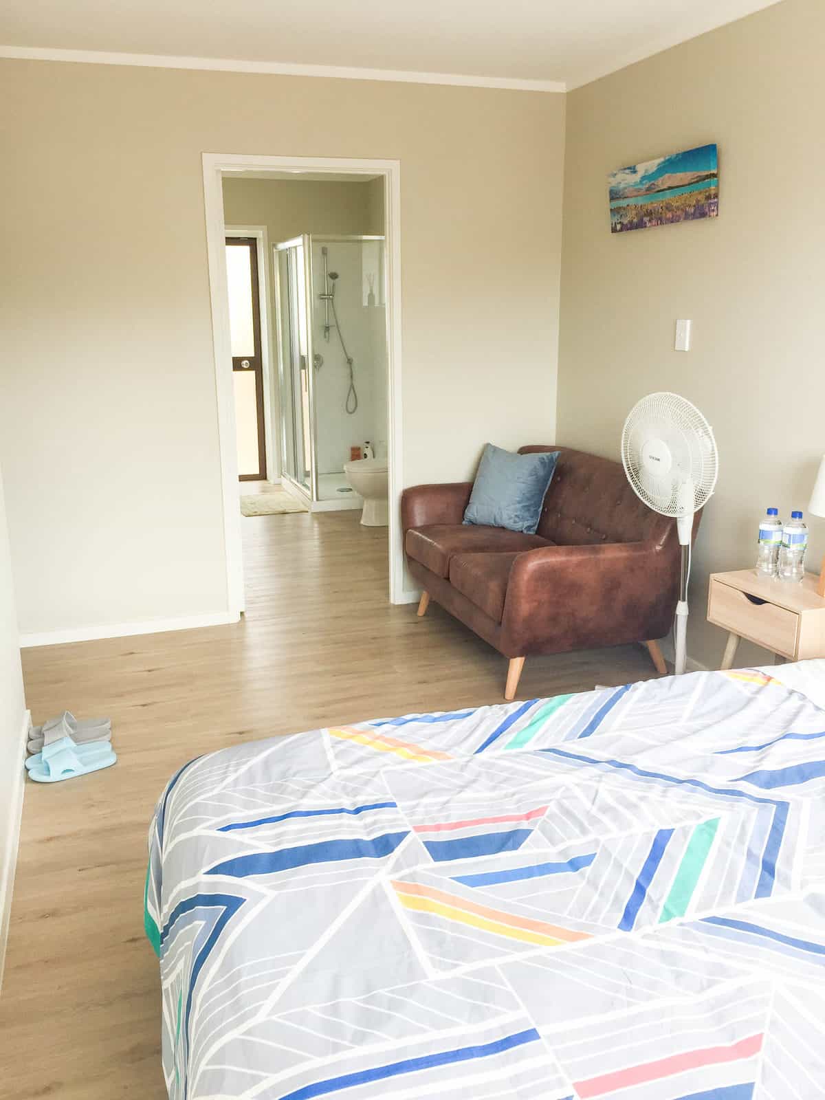 Existing bedroom with a doorway through to a bathroom, Mairangi Bay