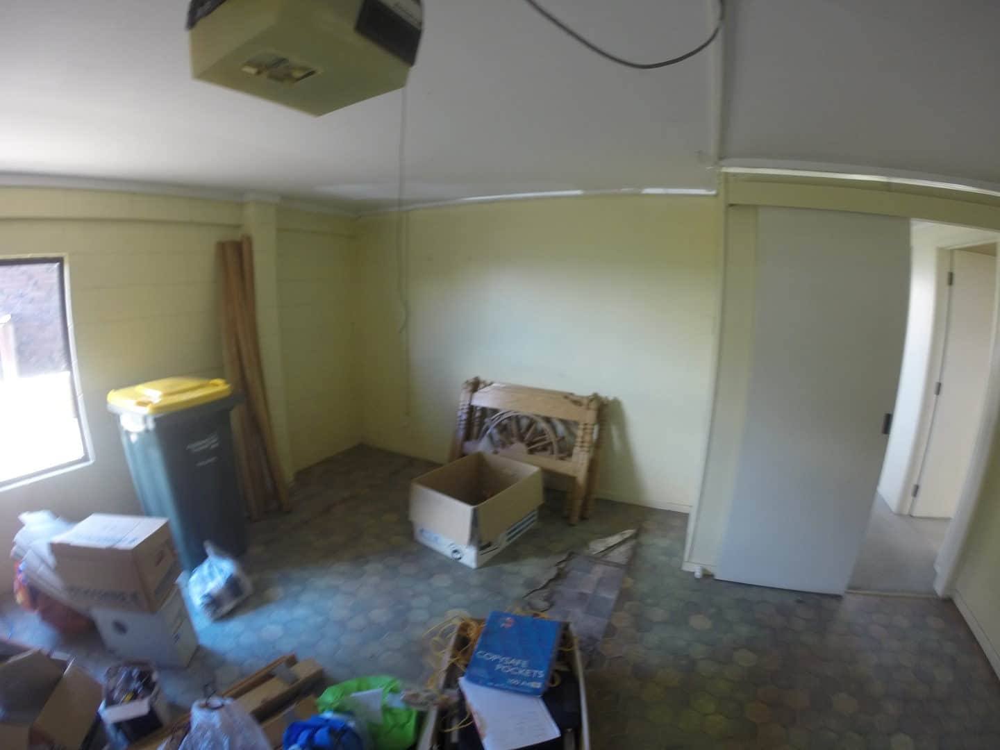 Existing room stripped back with boxes and vinyl flooring, Mairangi Bay