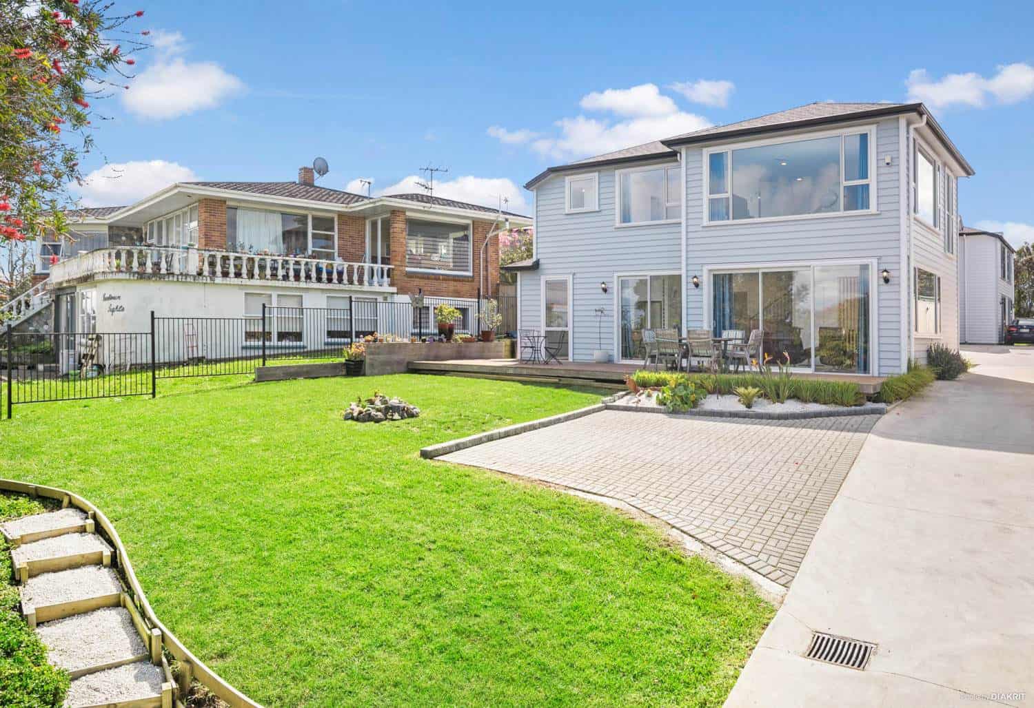 Lawn and planted bank looking up to the rear of the house, Mairangi Bay