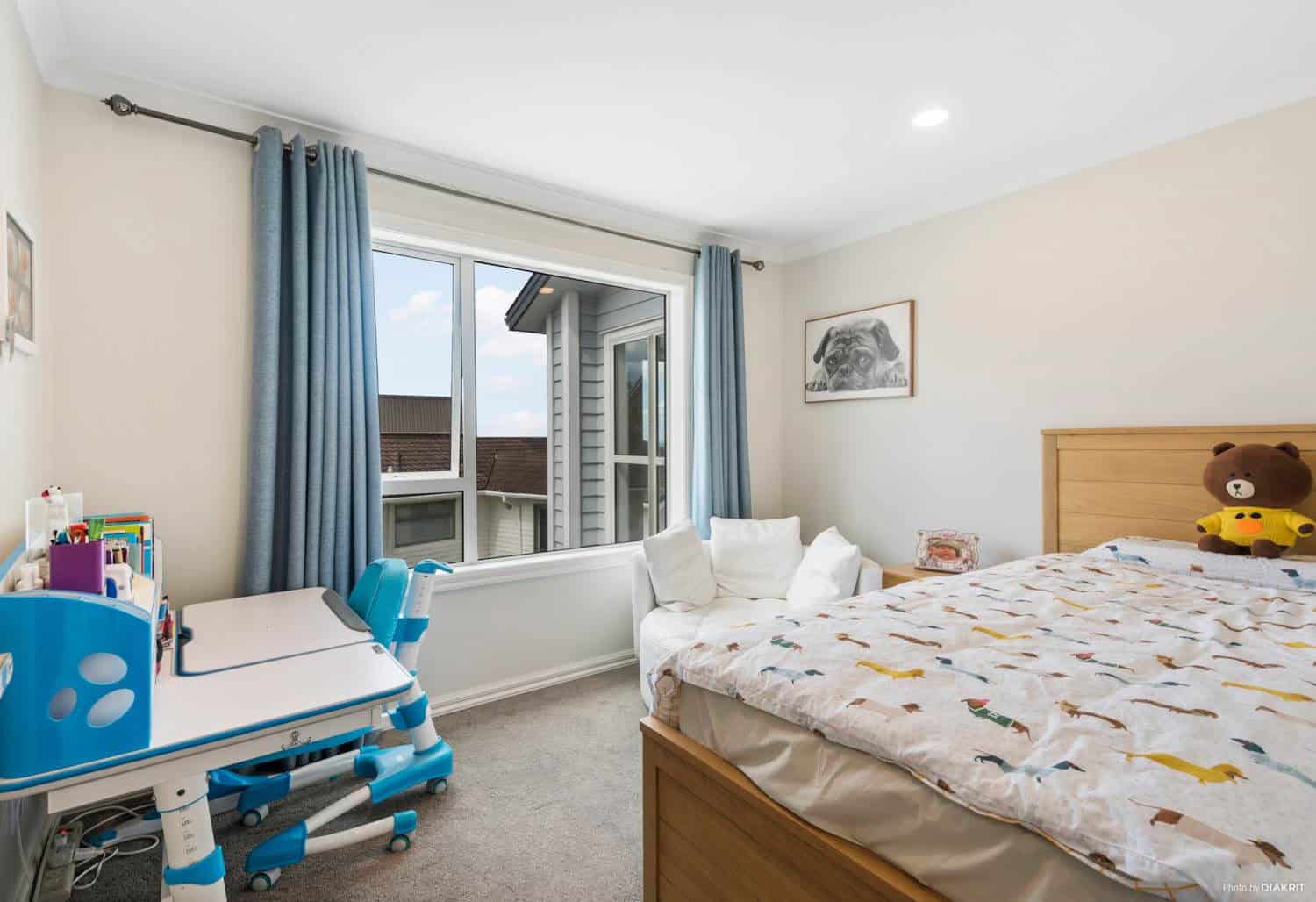 Child's bedroom with a desk beside the window, Mairangi Bay