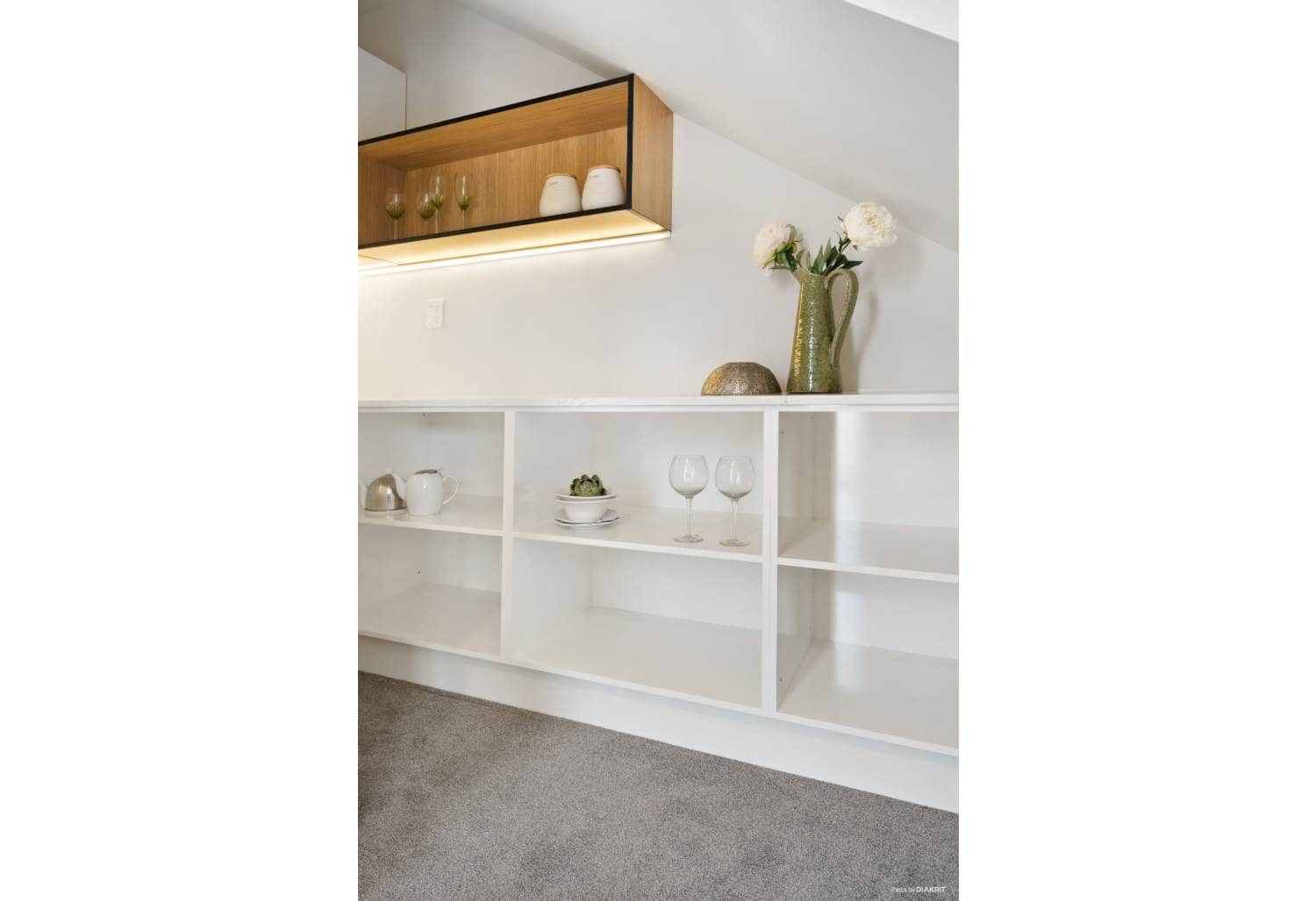 Built-in display shelving with concealed lighting, Mairangi Bay