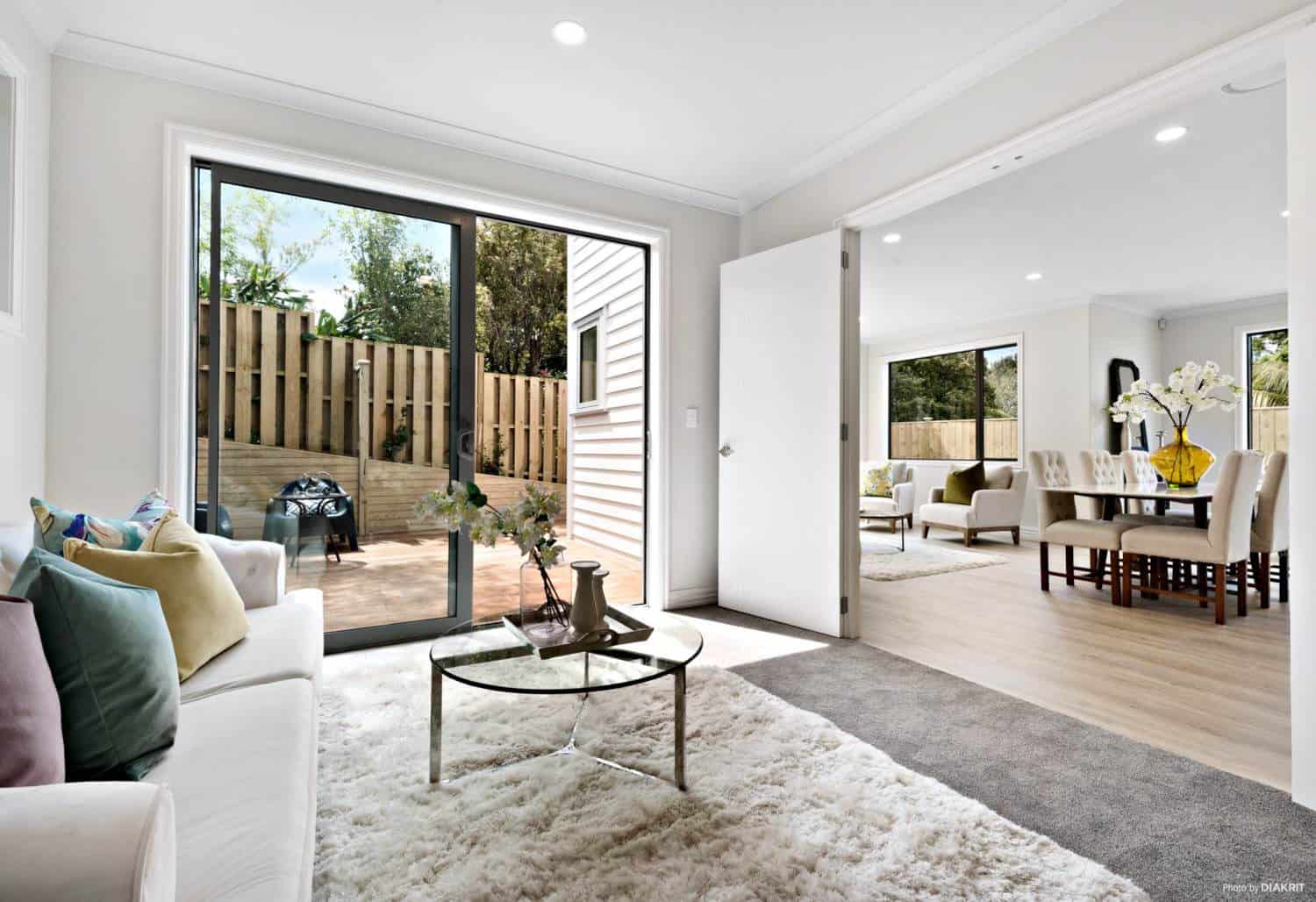 Living area looking through sliding doors to the deck and courtyard, Mairangi Bay