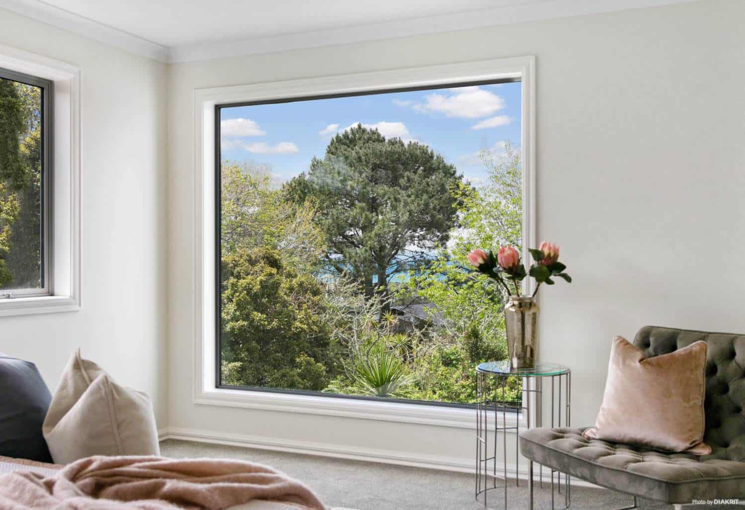 Corner window looking into a mature pohutukawa from the bedroom, Mairangi Bay