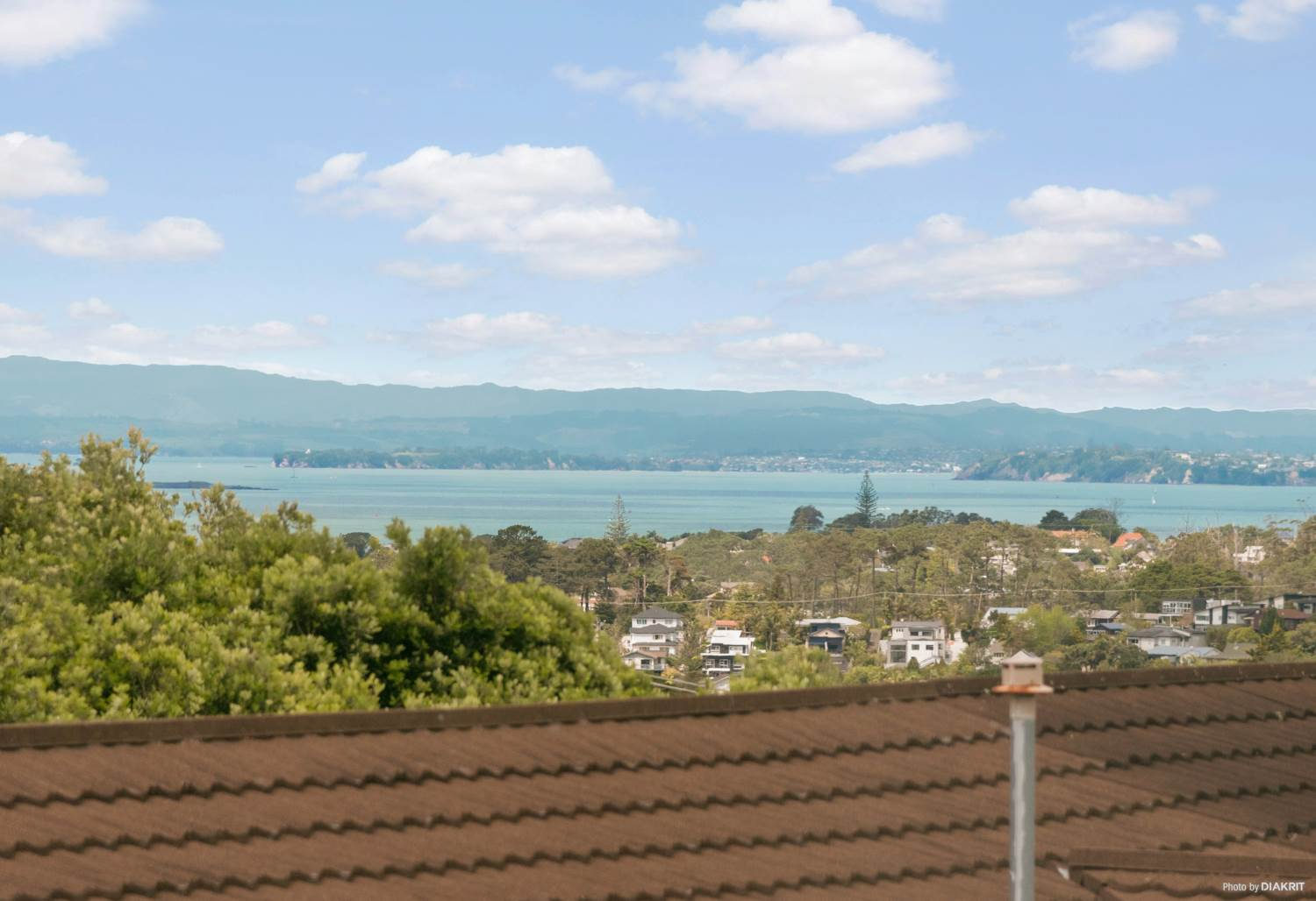 View from the upper level over tiled roofs to the harbour, Mairangi Bay