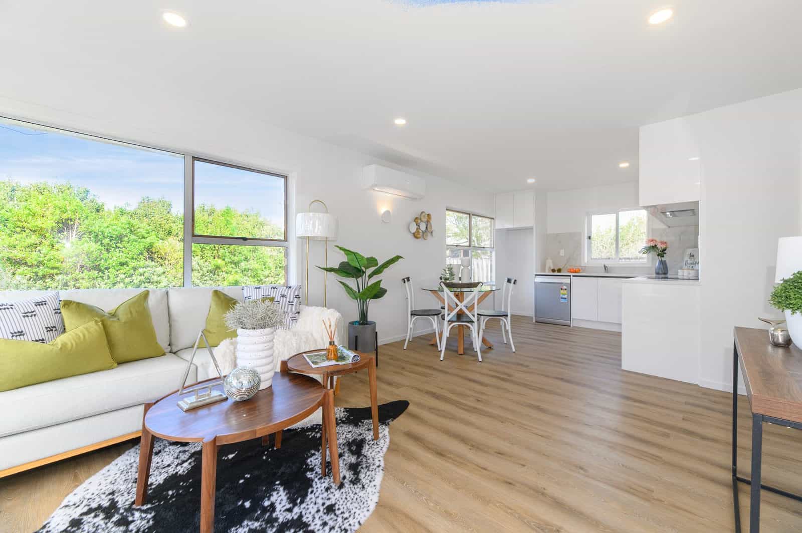 Open-plan living and kitchen with a sofa and dining table, Milford